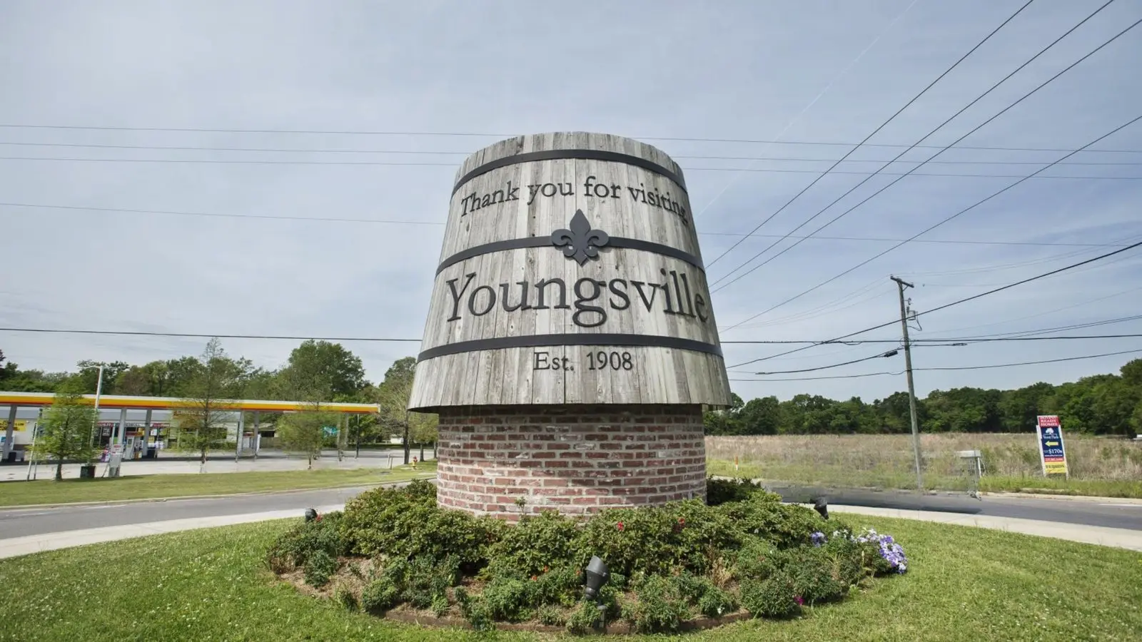 The Youngsville welcome sign, a wooden barrel on a brick base reading Thank you for visiting Youngsville, established 1908
